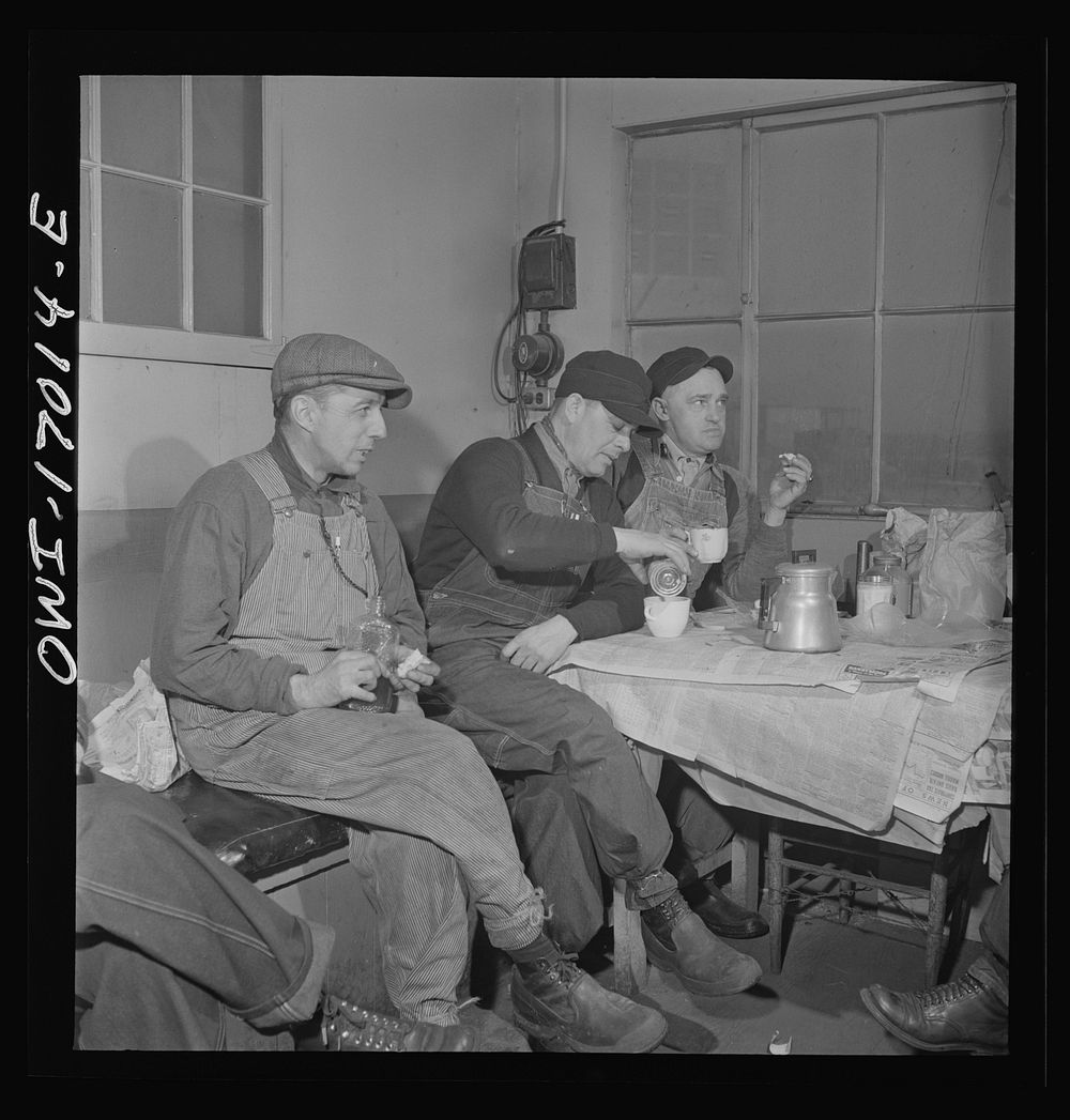 Daniel Senise at lunch in the work shanty at an Indiana Harbor Belt Line railroad yard. With him are (left) switchman John…