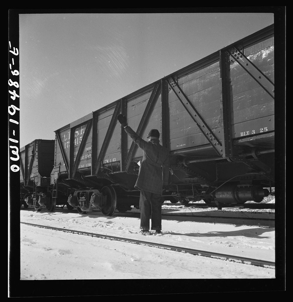 Joilet, Illinois. Conductor giving the brakeman the signal to apply and release the brakes before the train leaves on the…