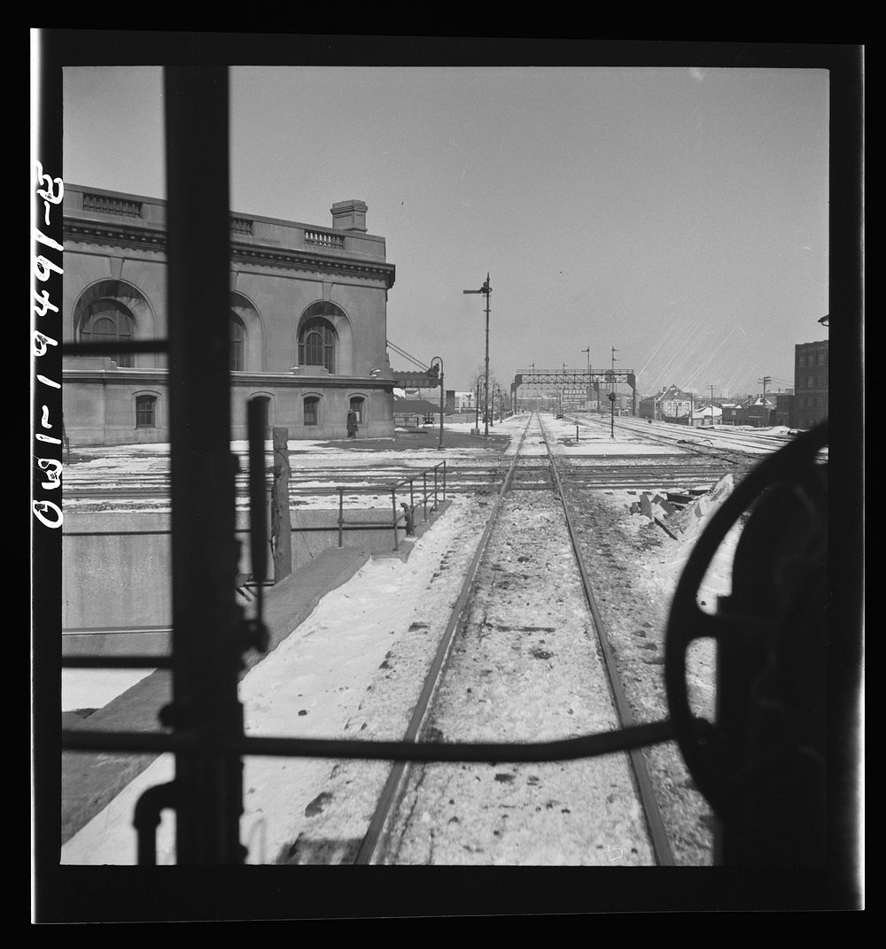 Joliet, Illinois. Passing the depot and tracks of the Rock Island and Alton Railroads along the Atchison, Topeka, and Santa…