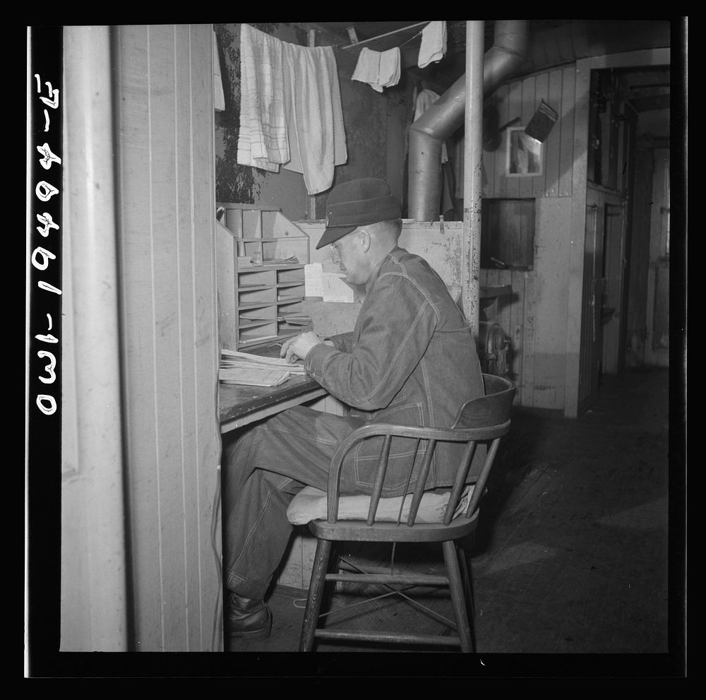 [Untitled photo, possibly related to: Conductor George E. Burton, having lunch in the caboose on the Atchison, Topeka, and…