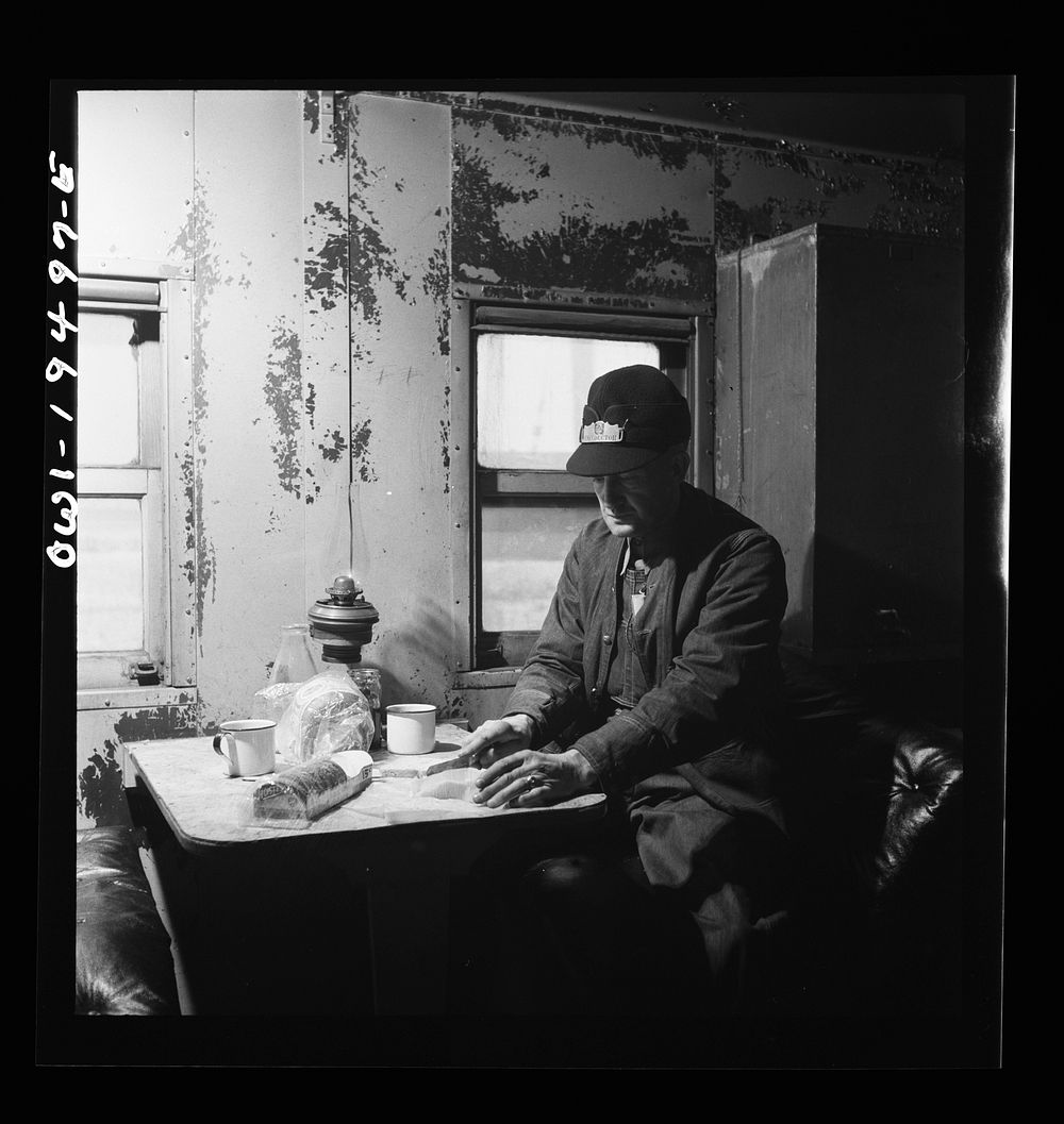 Conductor George E. Burton, having lunch in the caboose on the Atchison, Topeka, and Santa Fe Railroad between Chicago and…