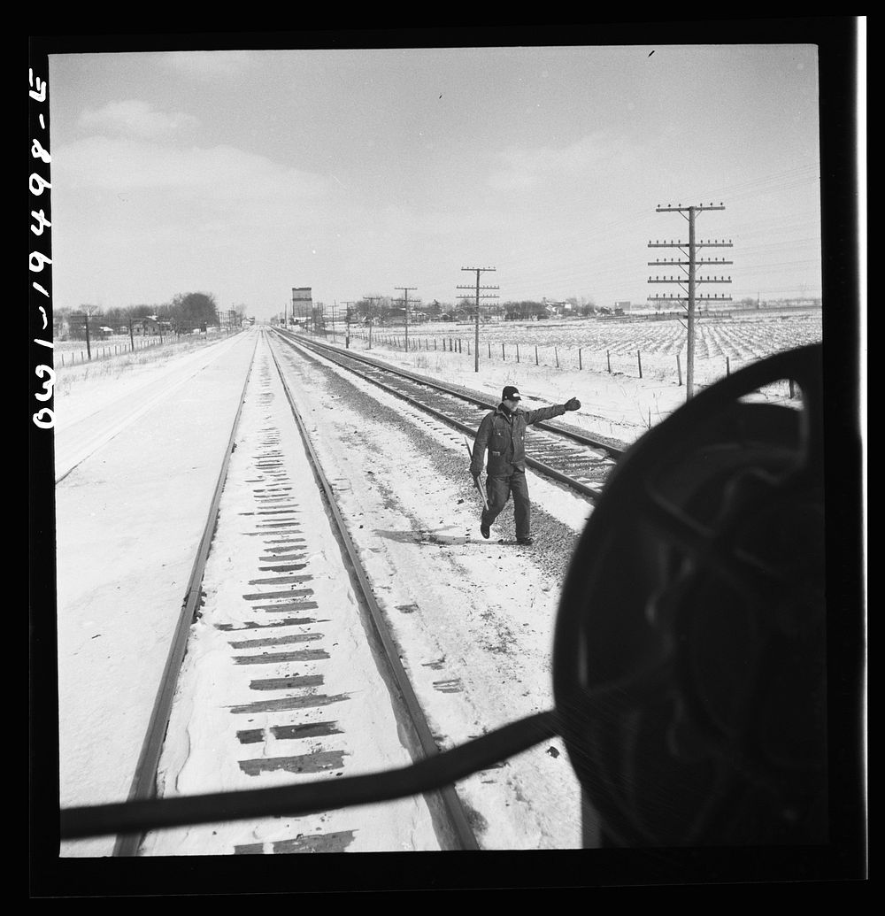 [Untitled photo, possibly related to: Verona, Illinois. The brakeman gives the highball sign after the train on the…