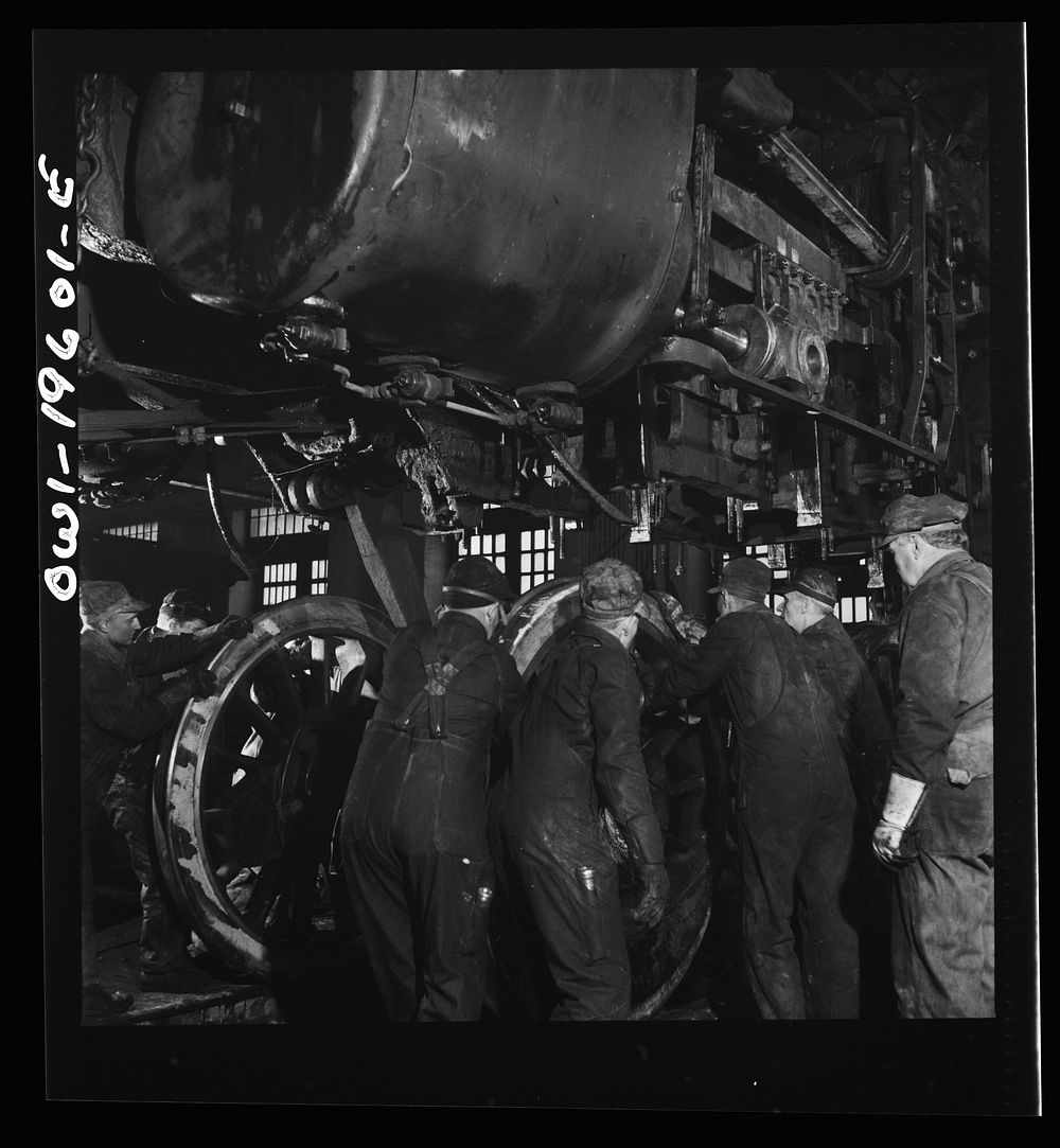 [Untitled photo, possibly related to: Fort Madison, Iowa. Wheeling an engine in the Shopton locomotive shops of the…