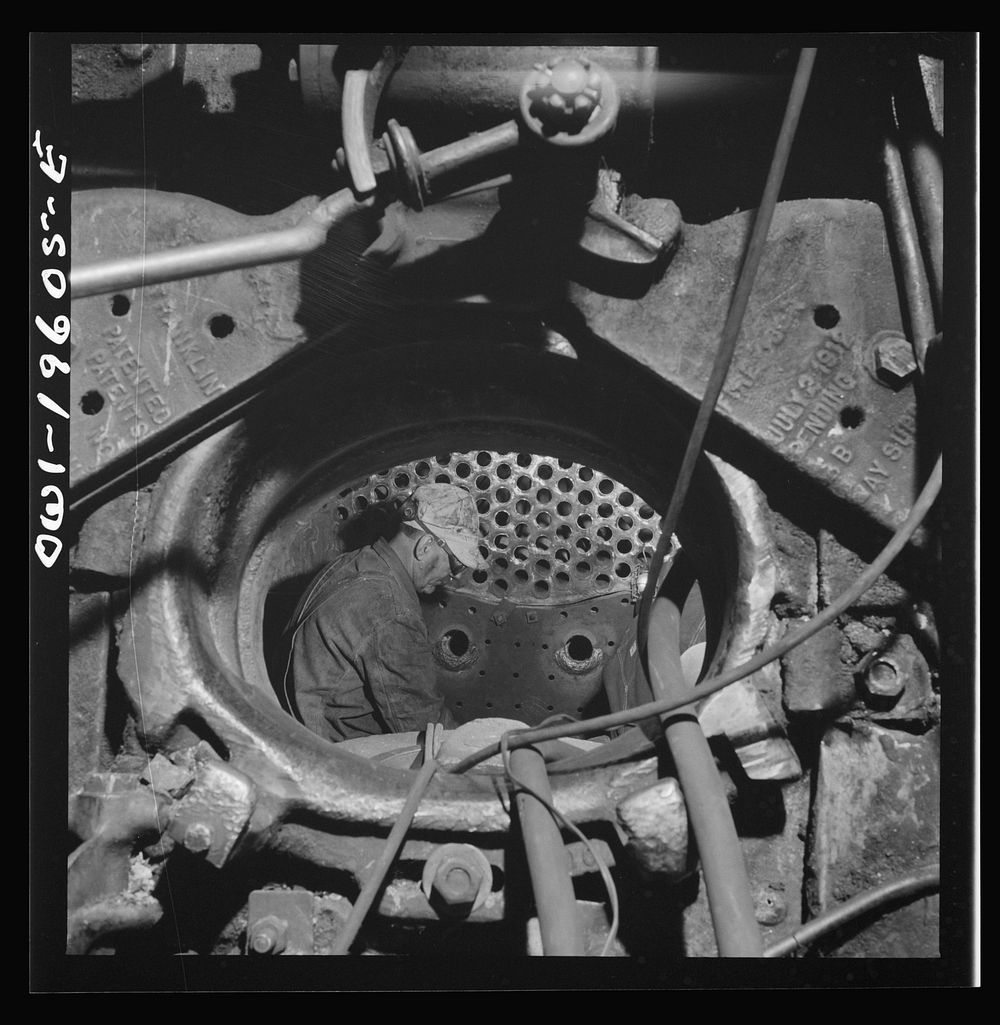 Fort Madison, Iowa. Boilermakers at work in the fire box at the Shopton locomotive shops of the Atchison, Topeka, and Santa…