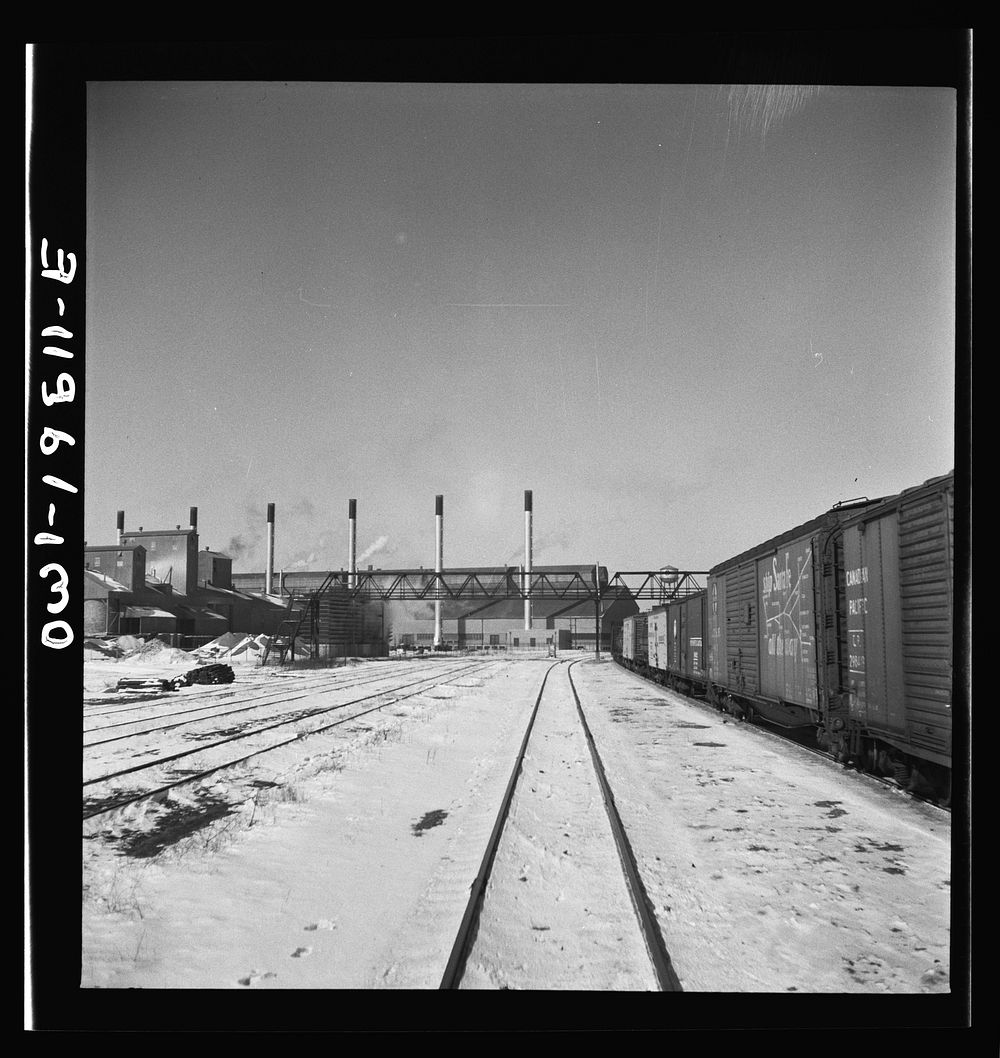 Streator, Illinois. Going through the Atchison, Topeka and Santa Fe Railroad yard. In the background is a large bottling…