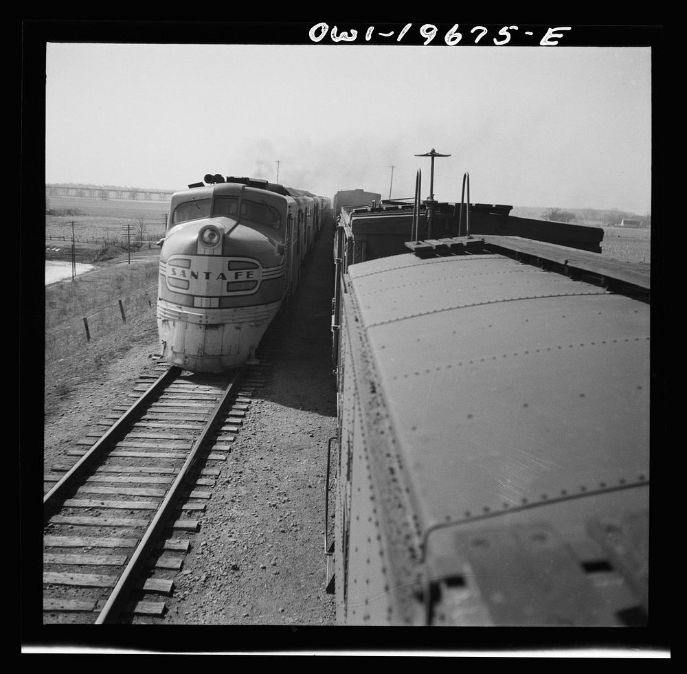 Sibley, Missouri. Passing one of the diesel passenger locomotives of the Atchison, Topeka, and Santa Fe Railroad. Sourced…