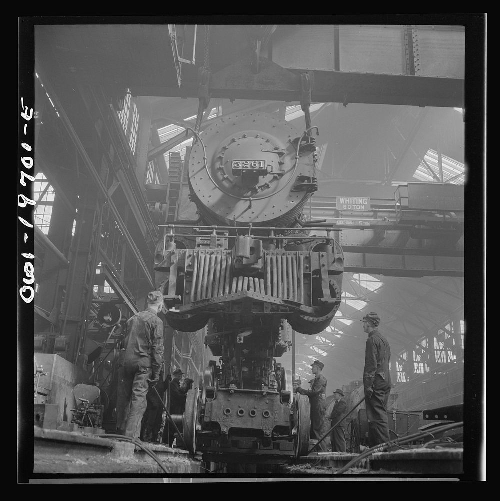 Topeka, Kansas. Wheeling an engine in the Atchison, Topeka, and Santa Fe Railroad locomotive shops. Sourced from the Library…