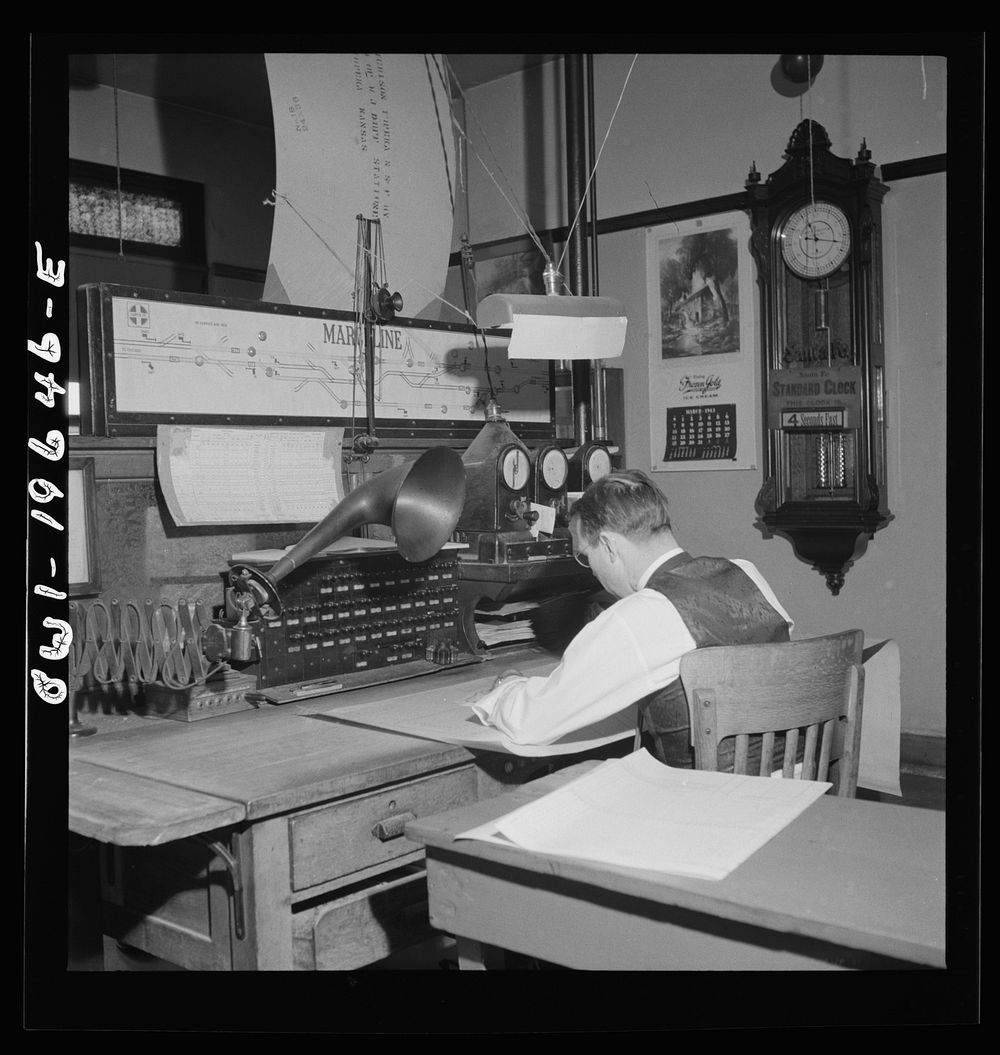 [Untitled photo, possibly related to: Marceline, Missouri. A dispatcher at work in the Atchison, Topeka, and Santa Fe…
