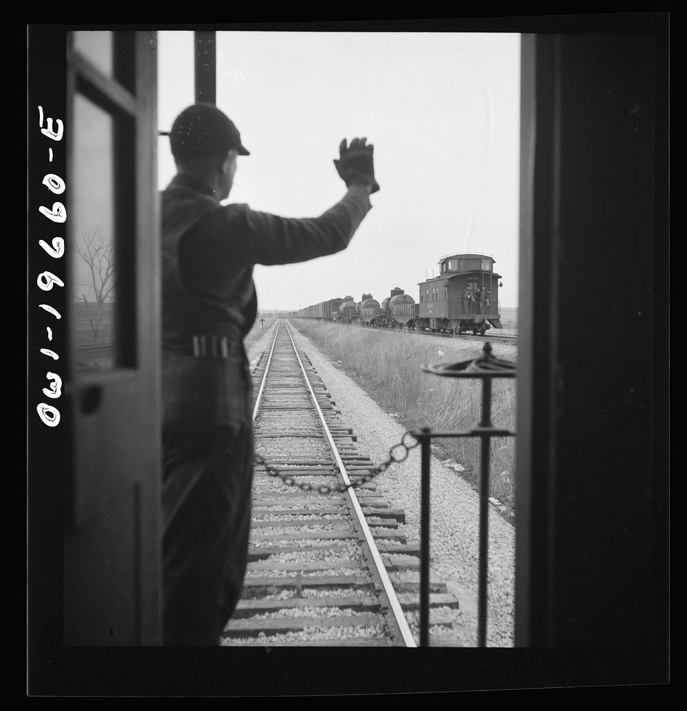 On the Atchison, Topeka, and Santa Fe Railroad between Marceline, Missouri and Argentine, Kansas. Brakemen exchanging…