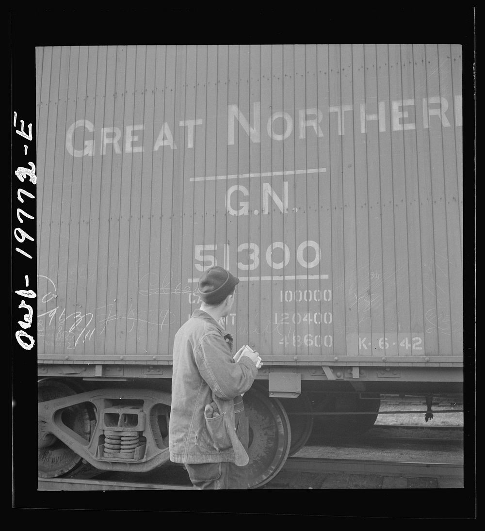 Argentine, Kansas. A brakeman checking the car numbers of his Atchison, Topeka and Santa Fe train before pulling out of the…