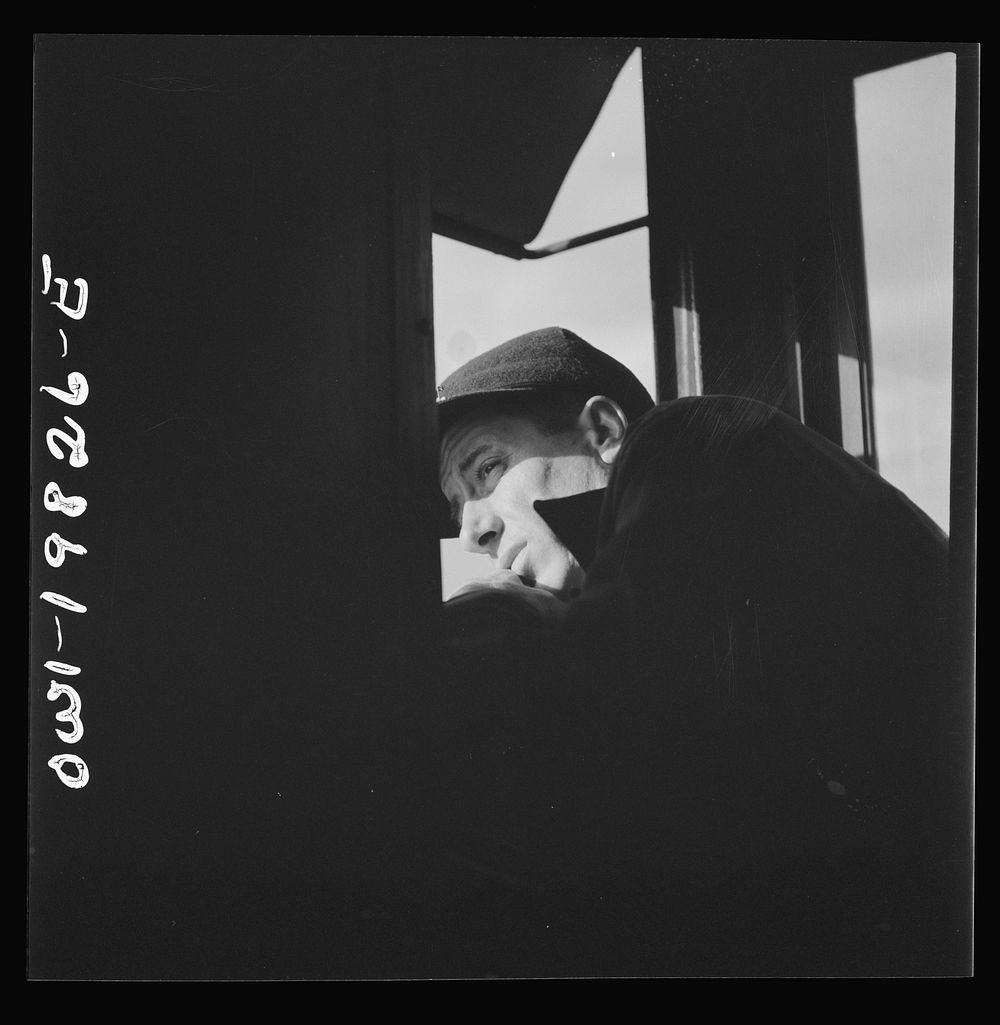 Brakeman H. L. Duffield, watching the train from the window in the cupola of the caboose on the Atchison, Topeka, and Santa…