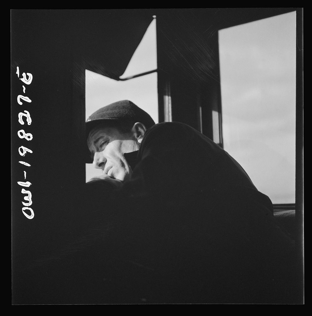 [Untitled photo, possibly related to: Brakeman H. L. Duffield, watching the train from the window in the cupola of the…