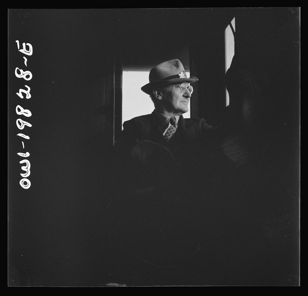 Conductor W. E. Zink, watching the train from his window in the cupola of the caboose on the Atchison, Topeka, and Santa Fe…