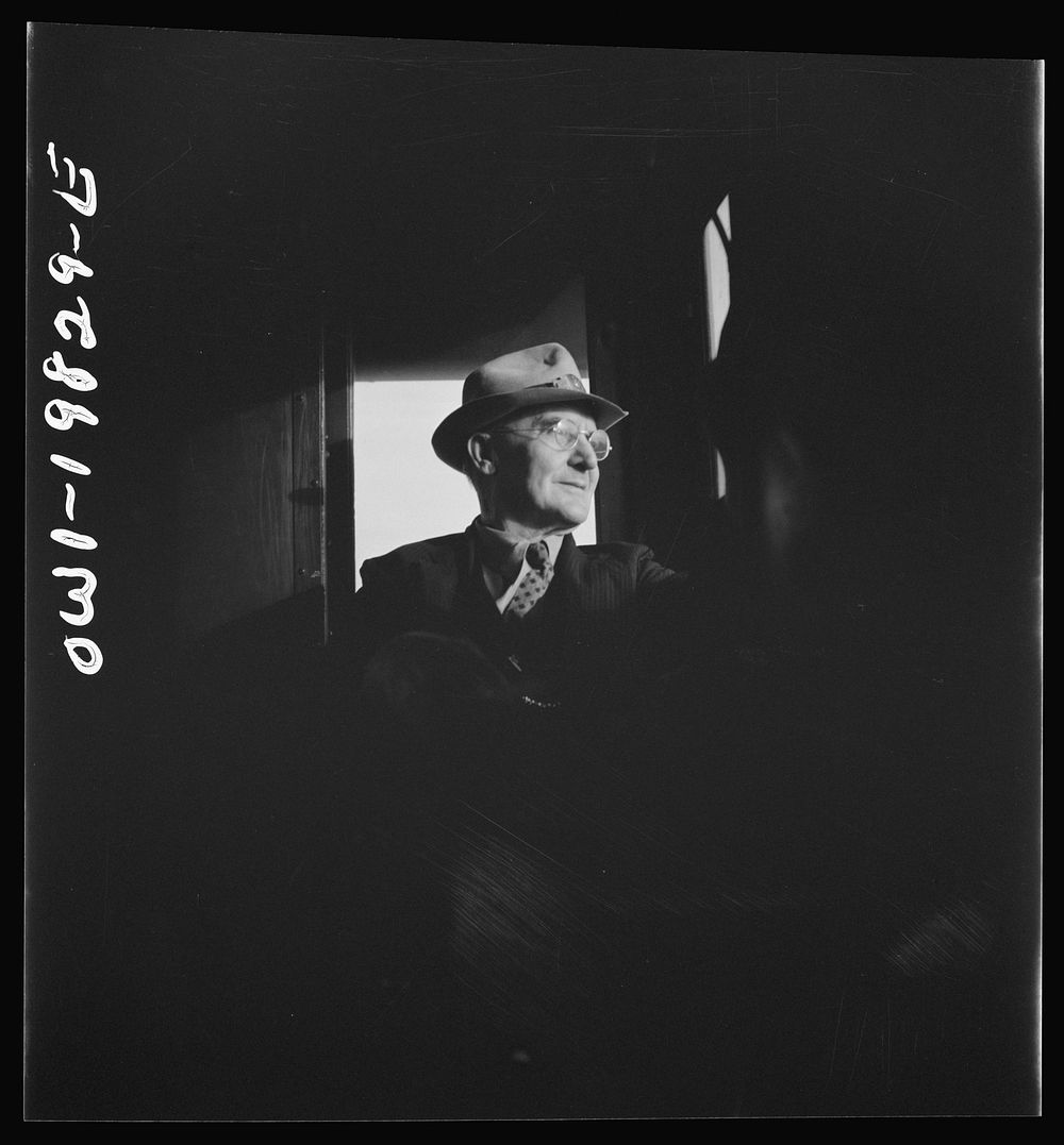 [Untitled photo, possibly related to: Conductor W. E. Zink, watching the train from his window in the cupola of the caboose…