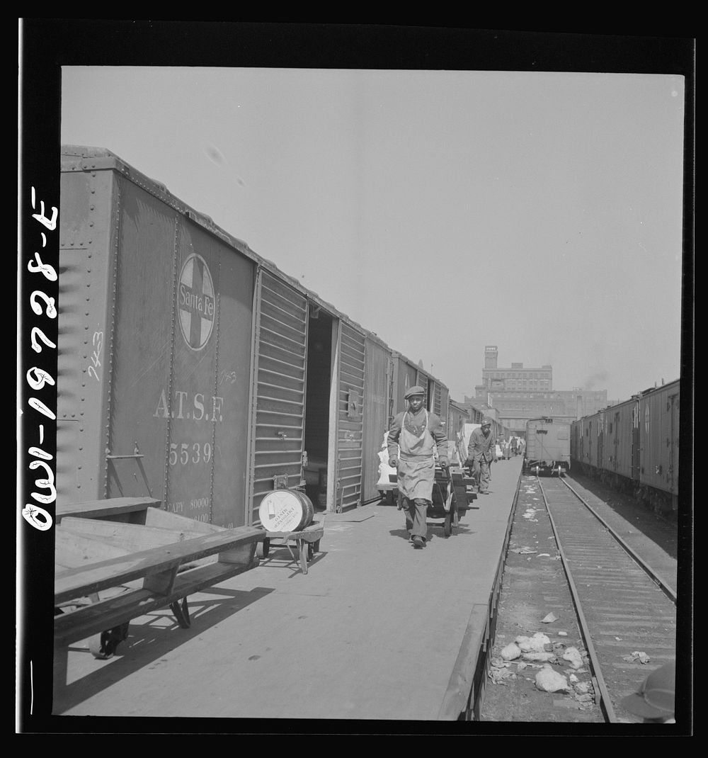 Kansas City, Missouri. Loading and unloading cars at the Atchison, Topeka, and Santa Fe freight depot. Sourced from the…