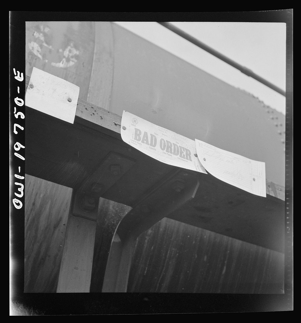 Topeka, Kansas. "Bad order" sign on a wrecked tank car in the shops of the Atchison, Topeka and Santa Fe Railroad. Sourced…