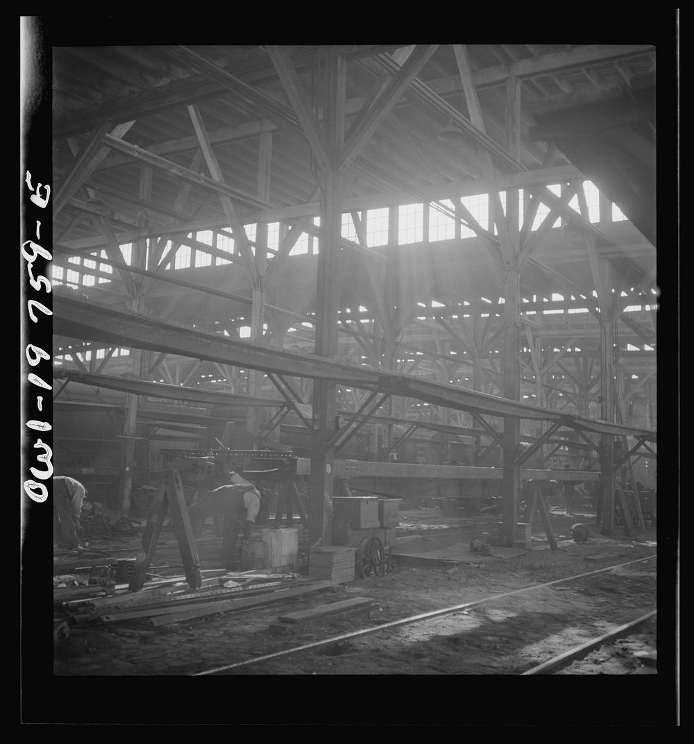[Untitled photo, possibly related to: Topeka, Kansas. In the shops of the Atchison, Topeka and Santa Fe Railroad, cars are…