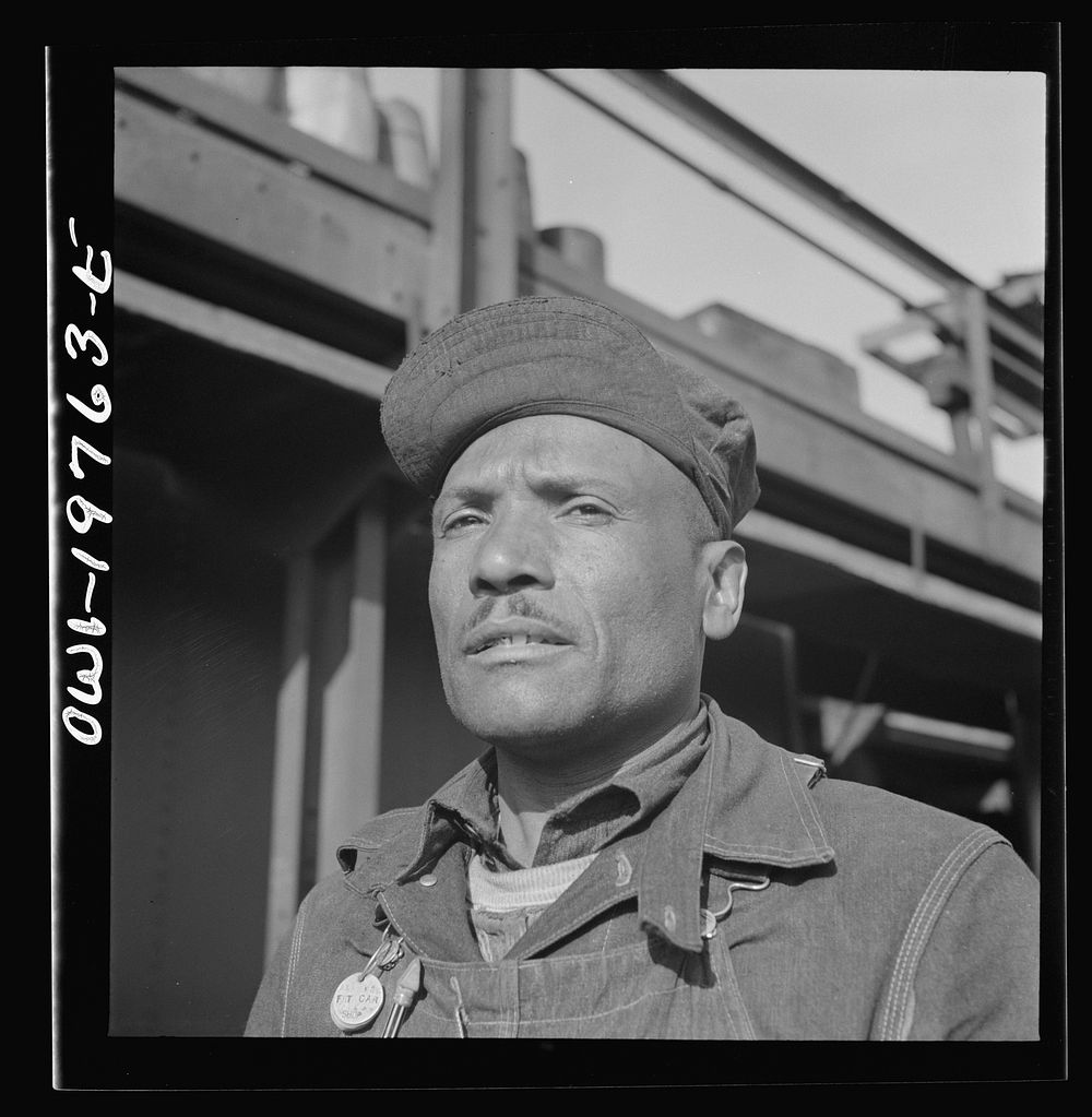 [Untitled photo, possibly related to: Topeka, Kansas. Manny Hughes, steel car repairer's helper and rivet heater, at the car…