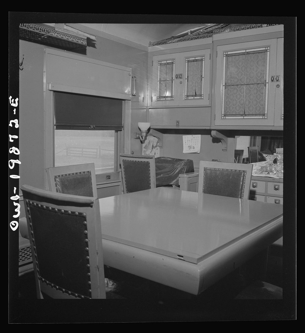 Dining room of the business car is used by the Atchison, Topeka, and Santa Fe division superintendent of Wellington, Kansas.…