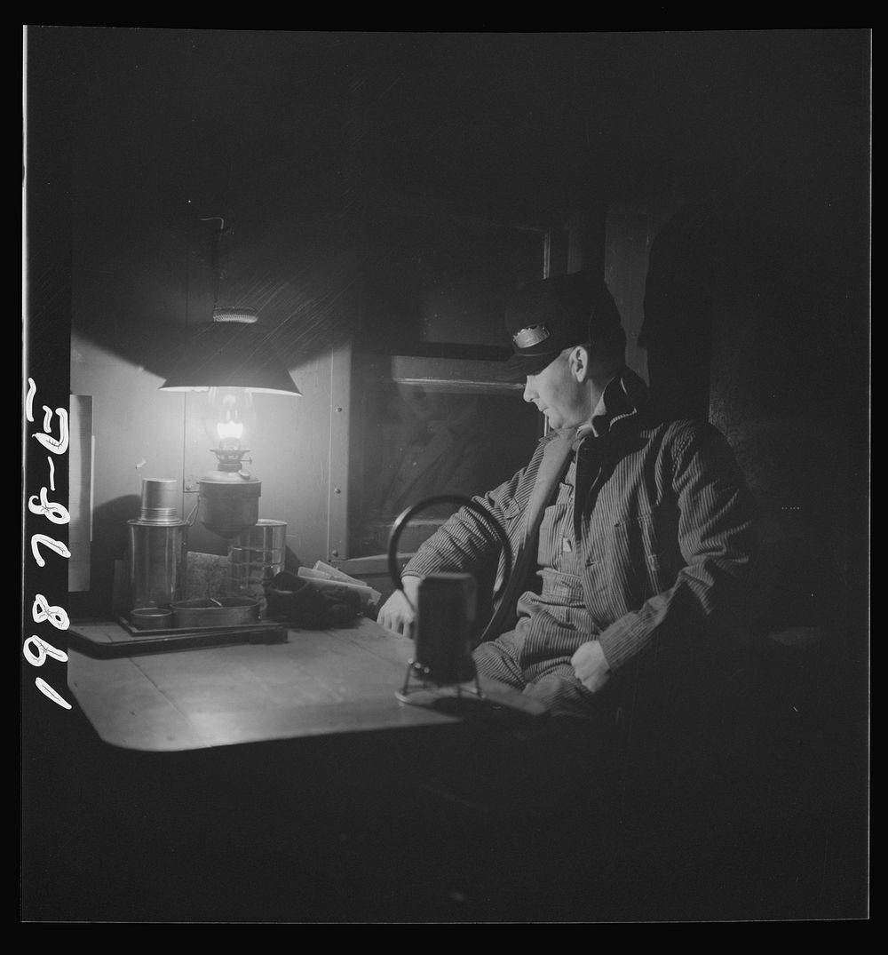 [Untitled photo, possibly related to: Waynoka, Oklahoma. Brakeman Jack Torbet, sitting at the window of the caboose pulling…