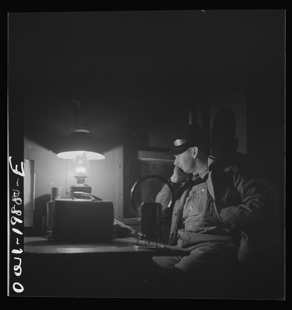[Untitled photo, possibly related to: Waynoka, Oklahoma. Brakeman Jack Torbet, sitting at the window of the caboose pulling…