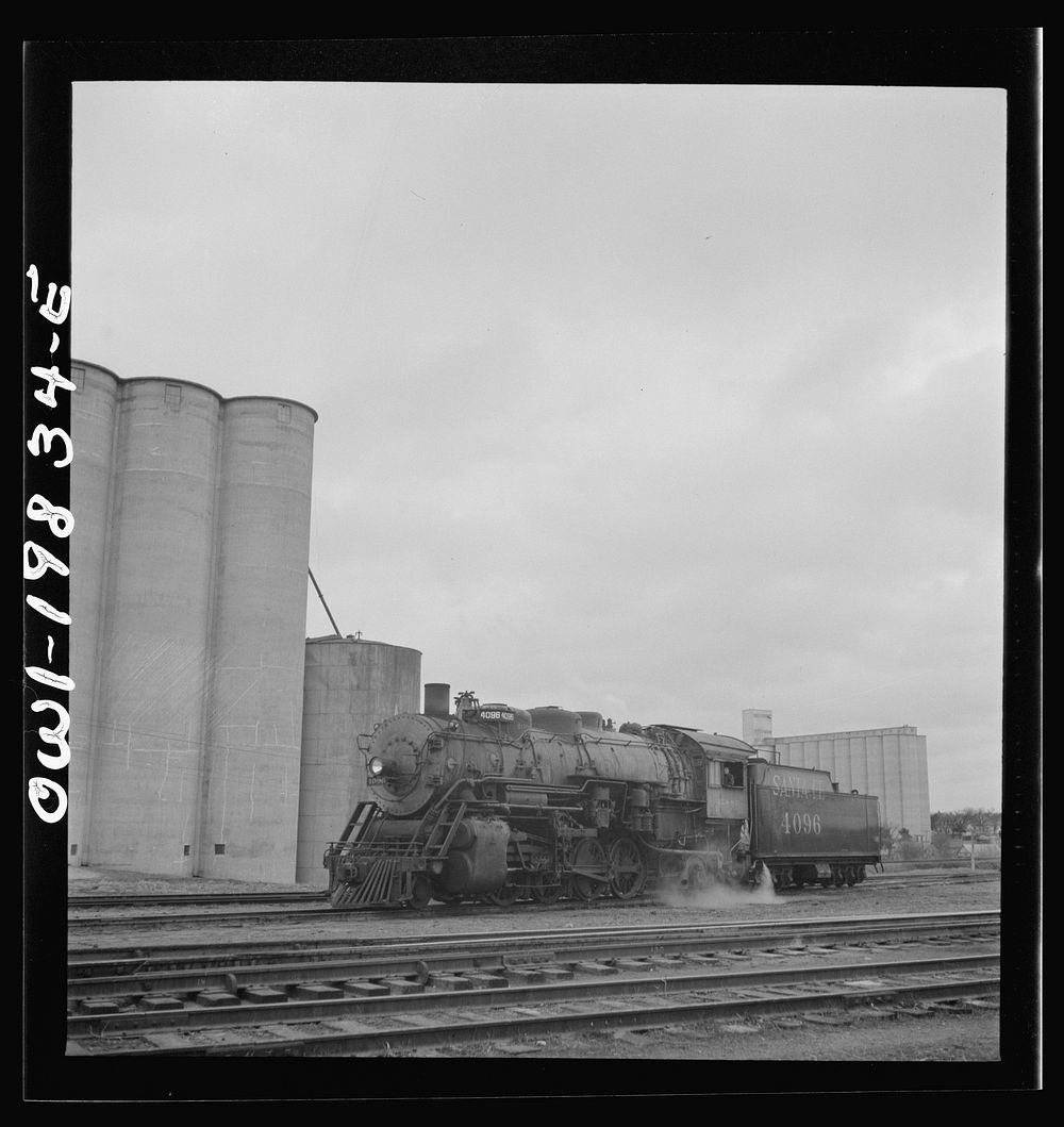 Atchison, Topeka, and Santa Fe Railroad train arriving at Wellington; the engine is uncoupled and sent off to the…
