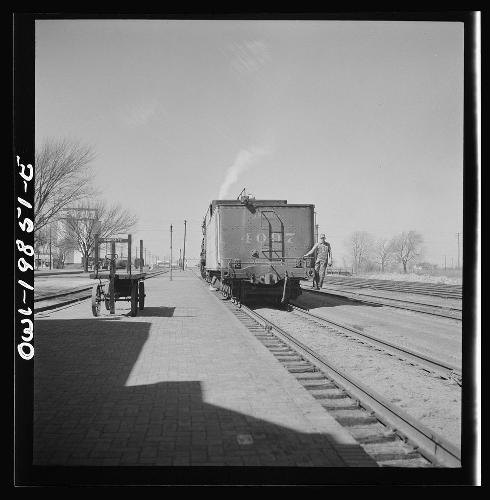 Harper, Kansas. Engine going off to get water at opposite end of the platform on the Atchison, Topeka and Santa Fe Railroad…
