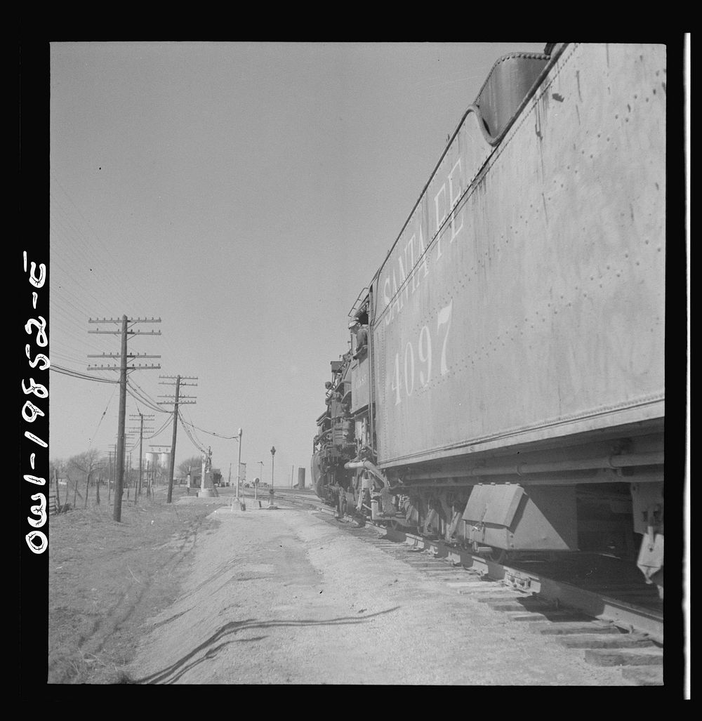 [Untitled photo, possibly related to: Kiowa, Kansas. Train waiting for a block signal along the Atchison, Topeka and Santa…