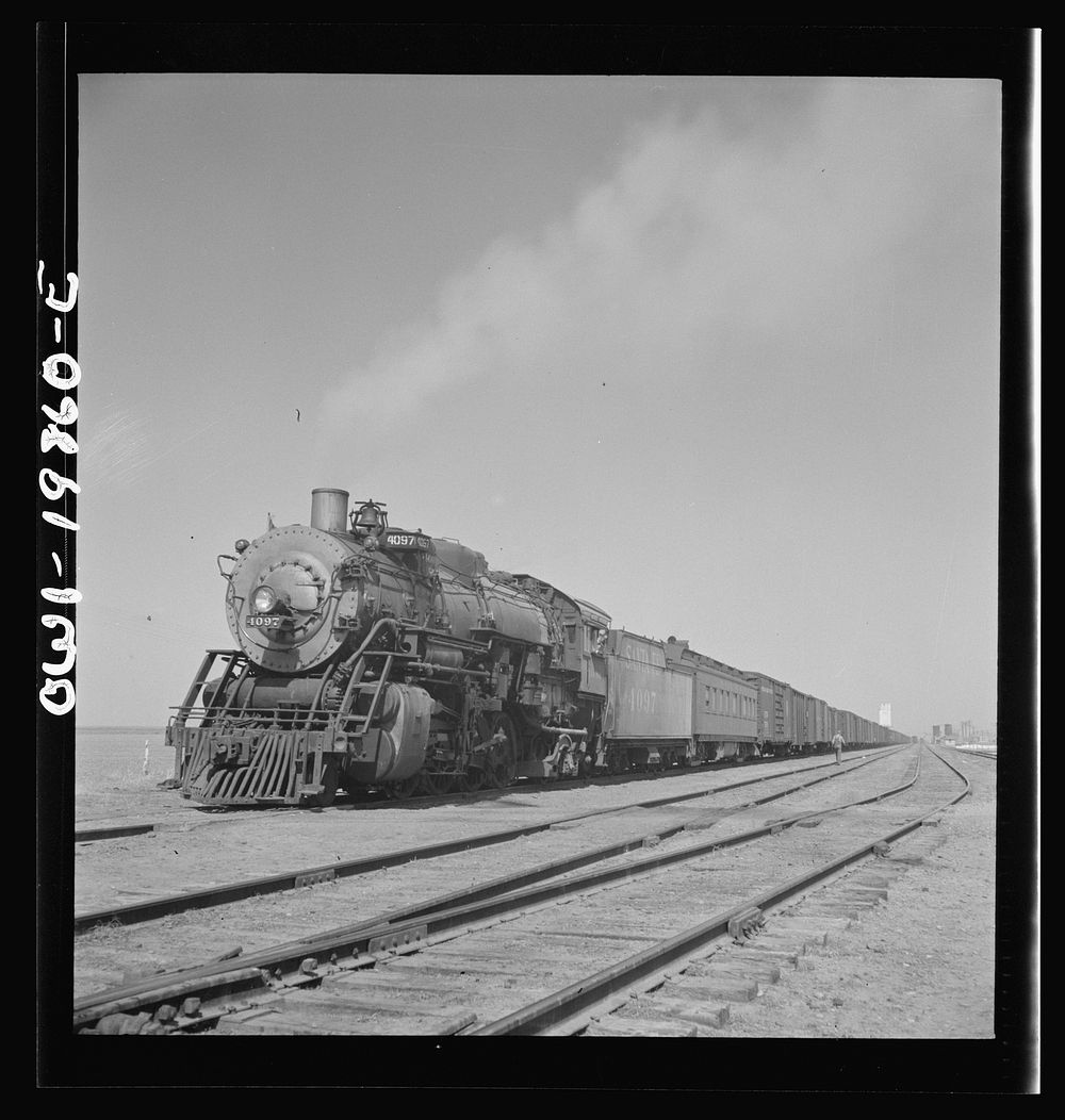 [Untitled photo, possibly related to: Kiowa, Kansas. Freight train pulling out on the Atchison, Topeka and Santa Fe Railroad…