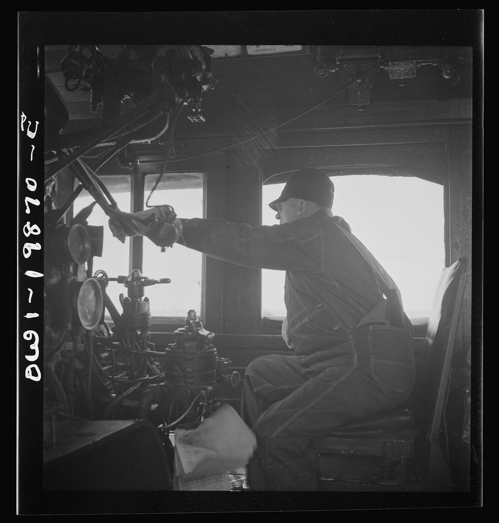 Kiowa, Kansas. Engineer B. F. Hale in the cab of his engine on the Atchison, Topeka, and Santa Fe Railroad between…