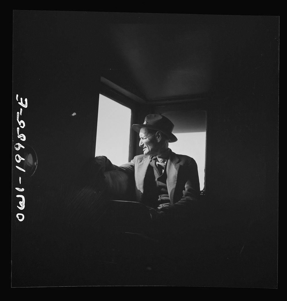 [Untitled photo, possibly related to: Conductor J.R. Crawford, watching the train from his window in the cupola of the…