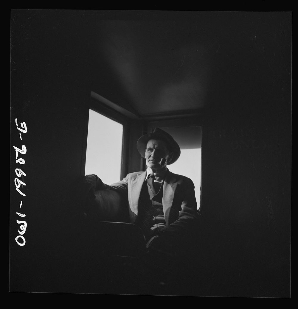 [Untitled photo, possibly related to: Conductor J.R. Crawford, watching the train from his window in the cupola of the…