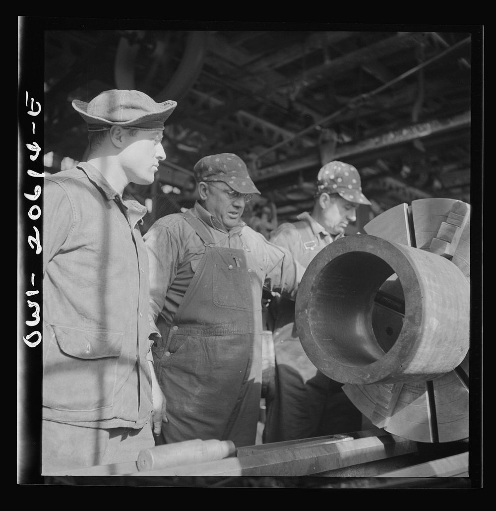 Clovis, New Mexico. A machinist in the Atchison, Topeka and Santa Fe Railroad locomotive shops, John Corey, working at an…