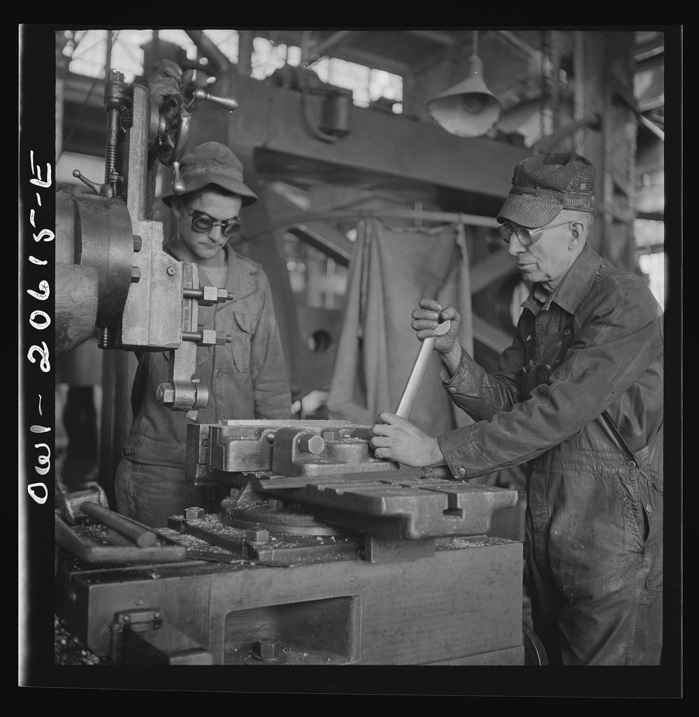 Clovis, New Mexico. Private Frank Donath of Sedalia, Missouri, learning to use a shaper under the direction of A.R. Rose…