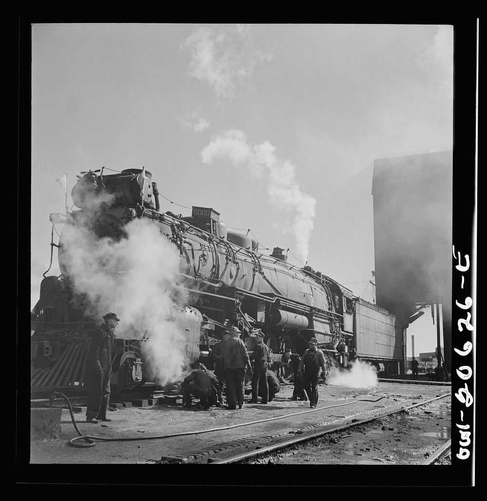 Clovis, New Mexico. Checking a locomotive as it leaves the roundhouse in the Atchison, Topeka and Santa Fe Railroad shops.…