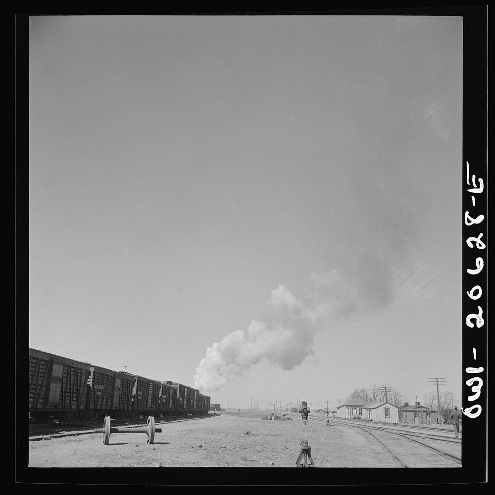 [Untitled photo, possibly related to: Clovis, New Mexico. Westbound freight train leaving the Atchison, Topeka and Santa Fe…