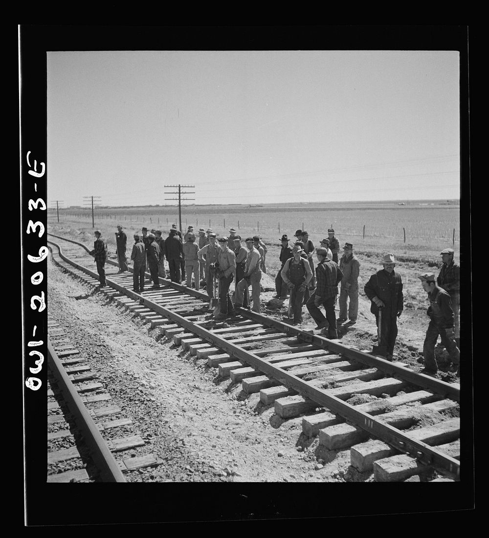Clovis, New Mexico. Passing a section gang at work on the outskirts along the Atchison, Topeka, and Santa Fe Railroad…