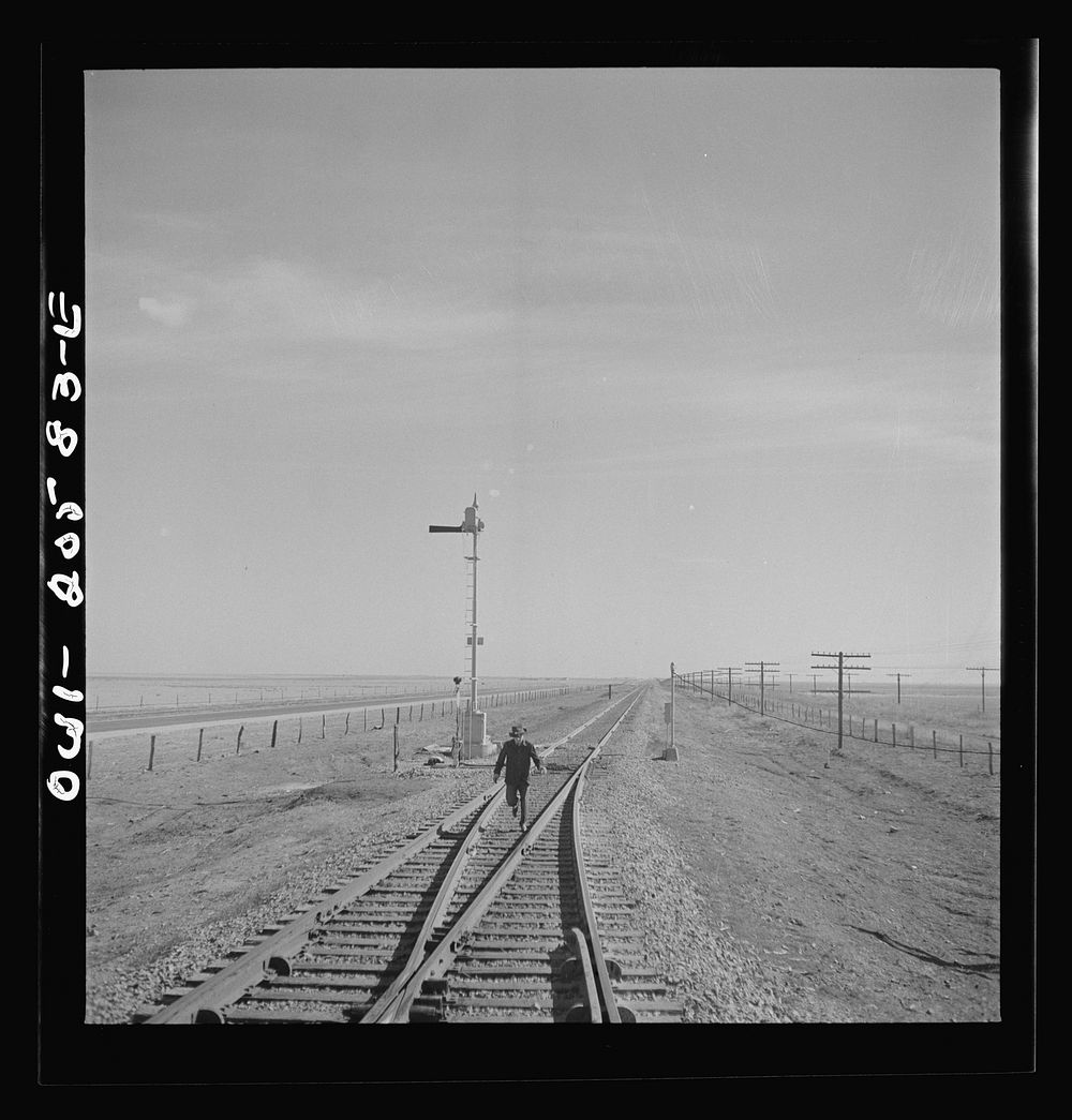 Sumnerfield, Texas. Brakeman running back to his train at the Atchison, Topeka, and Santa Fe Railroad between Amarillo…