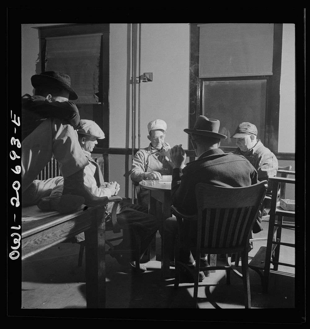 Vaughn, New Mexico. Railroad men playing dominoes in the Atchison, Topeka and Santa Fe Railroad yard reading room. Sourced…