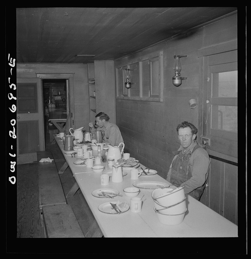 Iden, New Mexico. The last few workers have breakfast in the dining car of work train on the Atchison, Topeka and Santa Fe…