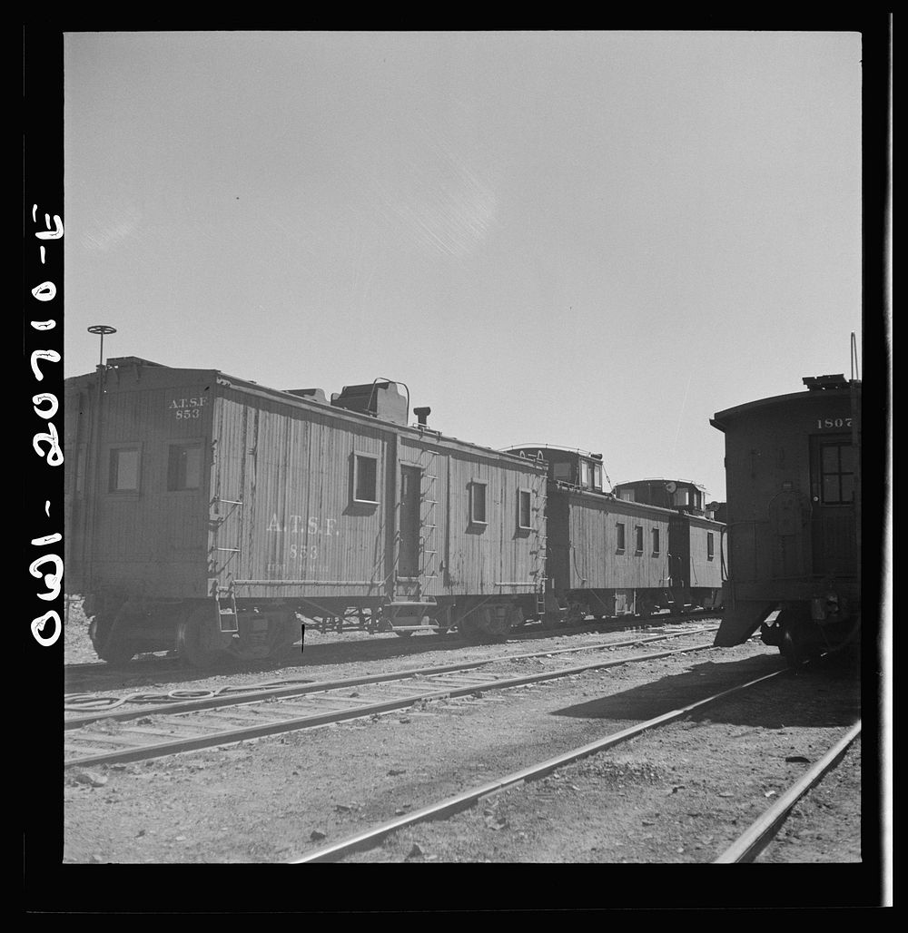 Vaughn, New Mexico. A caboose on the Atchison, Topeka and Santa Fe Railroad yard converted from an old box car. Sourced from…