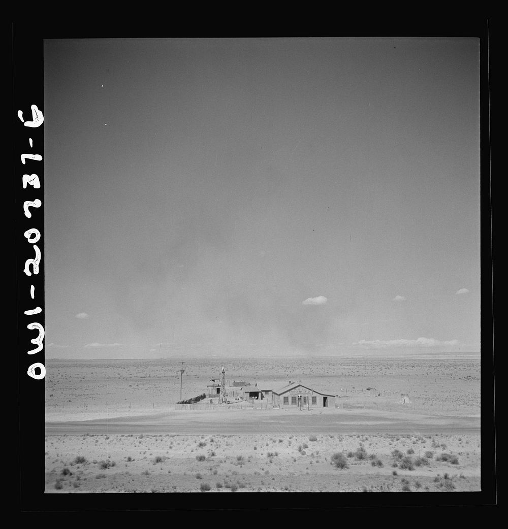 Willard, New Mexico. Passing a filling station in the desert country along the Atchison, Topeka and Santa Fe Railroad…
