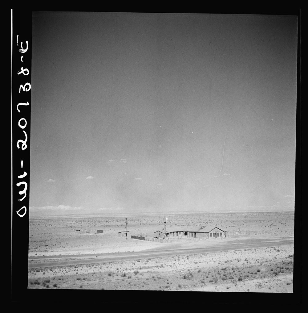 [Untitled photo, possibly related to: Willard, New Mexico. Passing a filling station in the desert country along the…