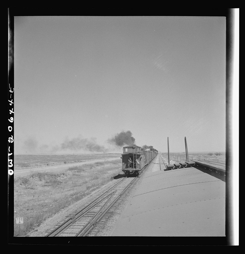 Tolar, New Mexico. Passing an east bound freight train along the Atchison, Topeka, and Santa Fe Railroad between Clovis and…