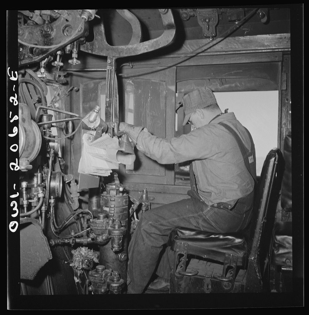 [Untitled photo, possibly related to: Ricardo, New Mexico. Engineer in his cab about to start the train along the Atchison…