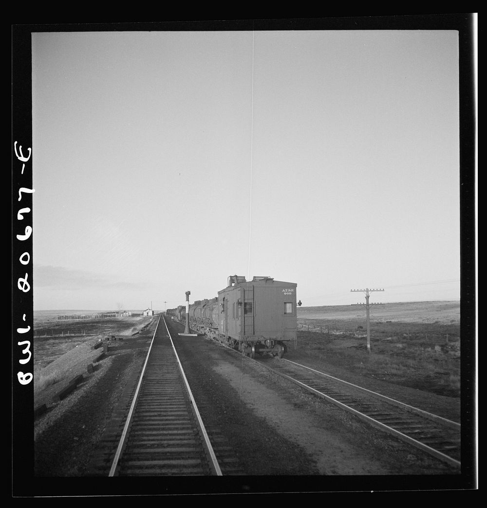 Duors, New Mexico. Passing a water train along the Atchison, Topeka, and Santa Fe Railroad between Clovis and Vaughn, New…
