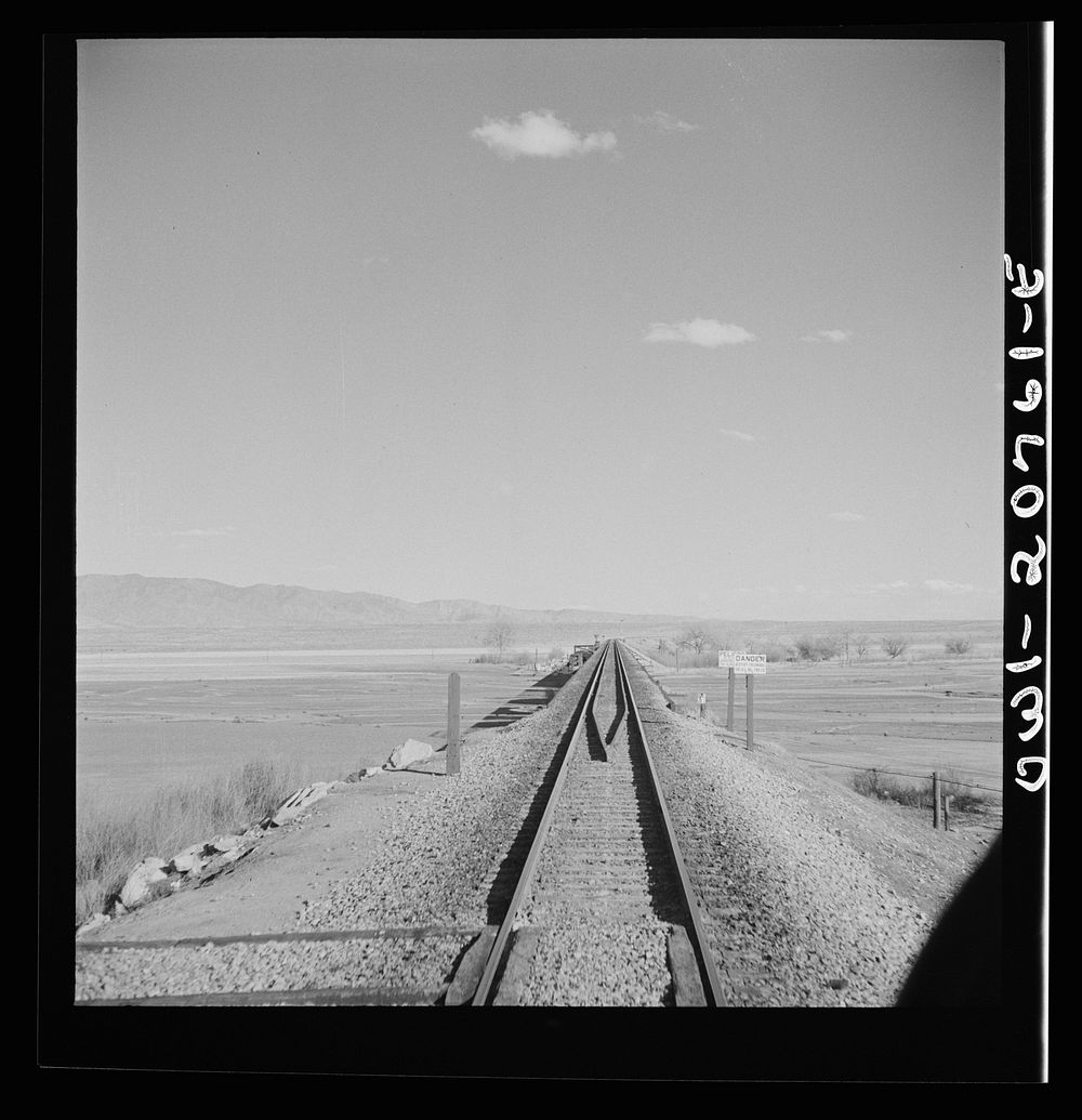 Belen, New Mexico. Going across the Rio Grande River Valley on the Atchison, Topeka and Santa Fe Railroad between Vaughn and…