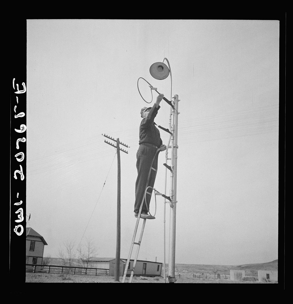 [Untitled photo, possibly related to: Isleta, New Mexico. Mr. Young standing on hoops with messages to be picked up by…