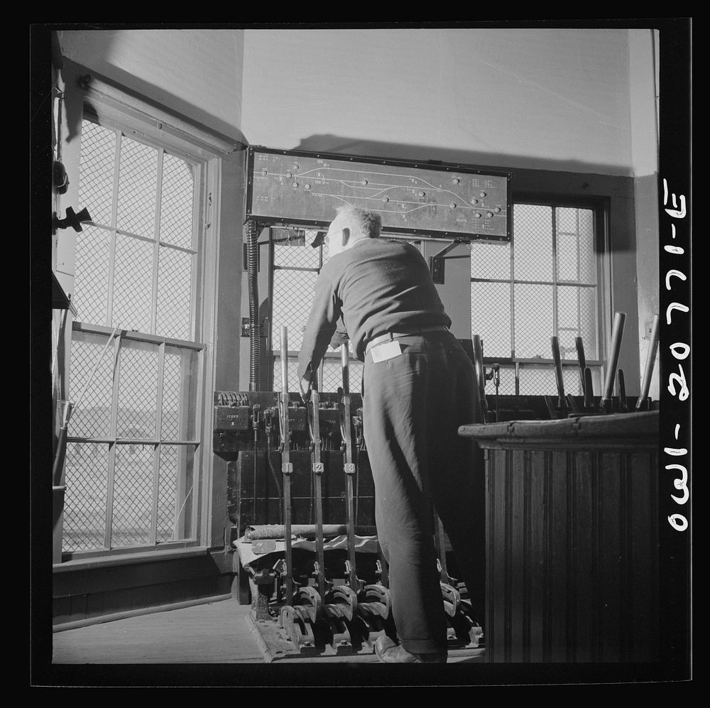 Isleta, New Mexico. Agent throwing one of the switches in the interlocking tower. Sourced from the Library of Congress.
