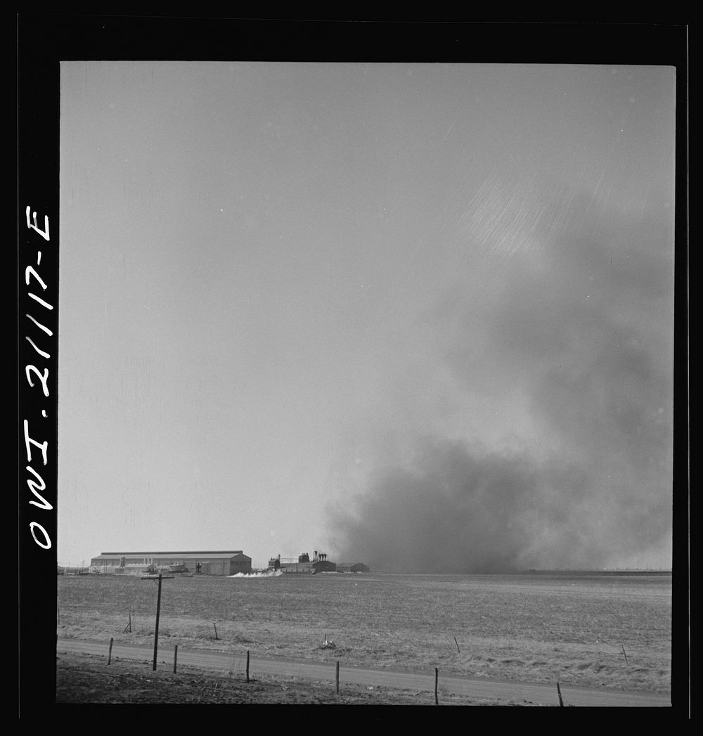 Pampa (vicinity), Texas. Passing a carbon  plant along the Atchison, Topeka and Santa Fe Railroad between Canadian and…